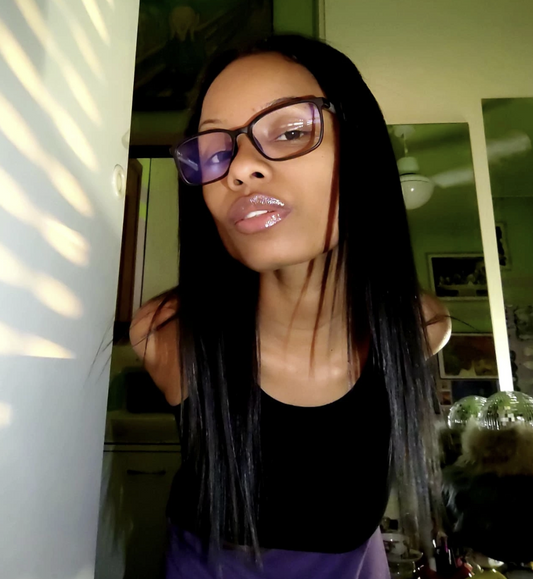 A woman wearing classic dark-rimmed rectangular eyeglasses