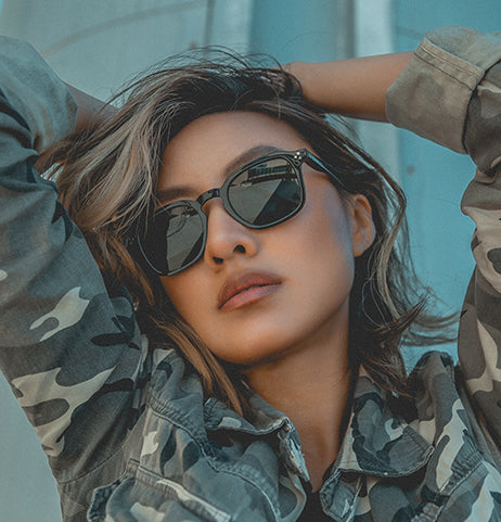 Zenottic sunglasses worn by a person in a camouflage jacket.